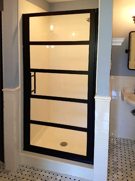  A corner shower with a tall curb
